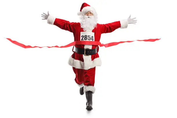 Full length portrait of Santa Claus on the finish line of a race isolated on white background